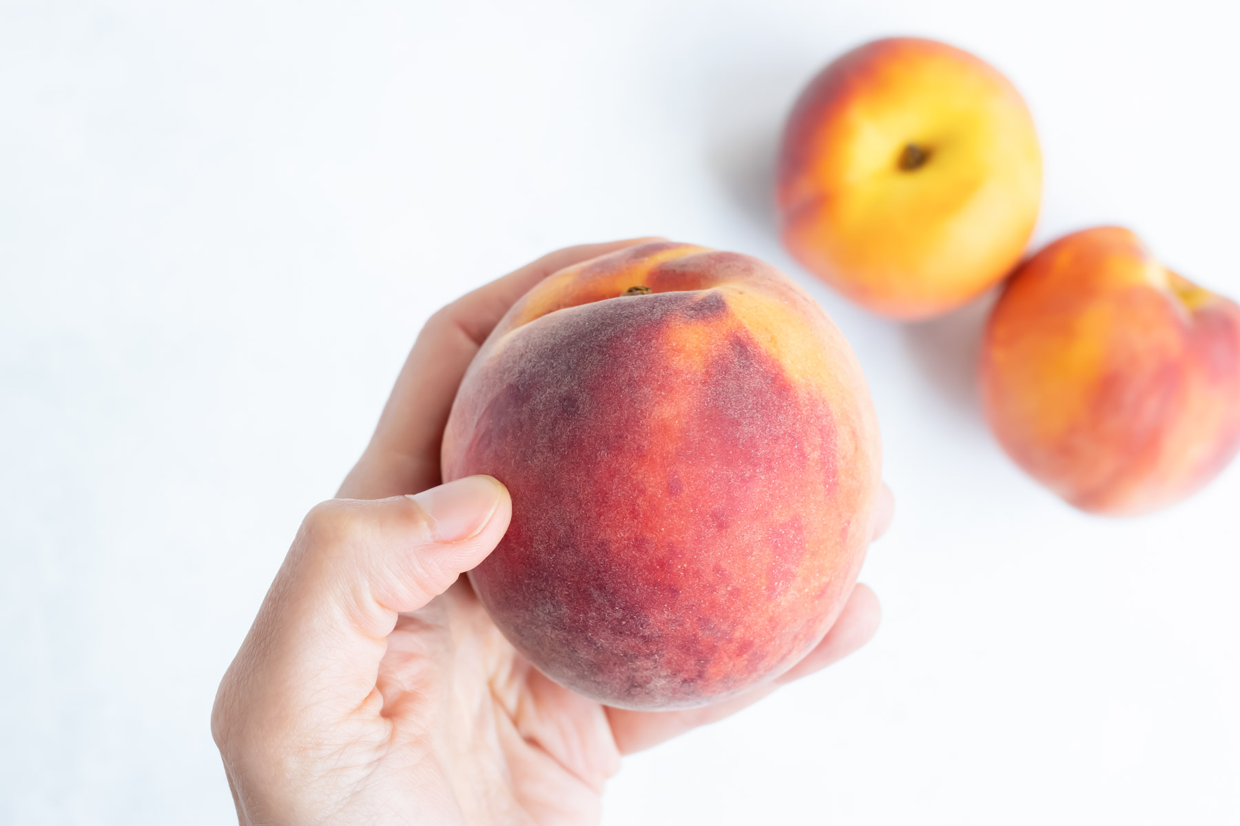 Gently press on a peach to see if it's ripe.