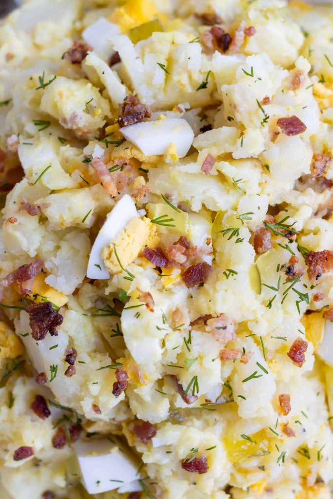 Southern potato salad is topped with chopped dill.