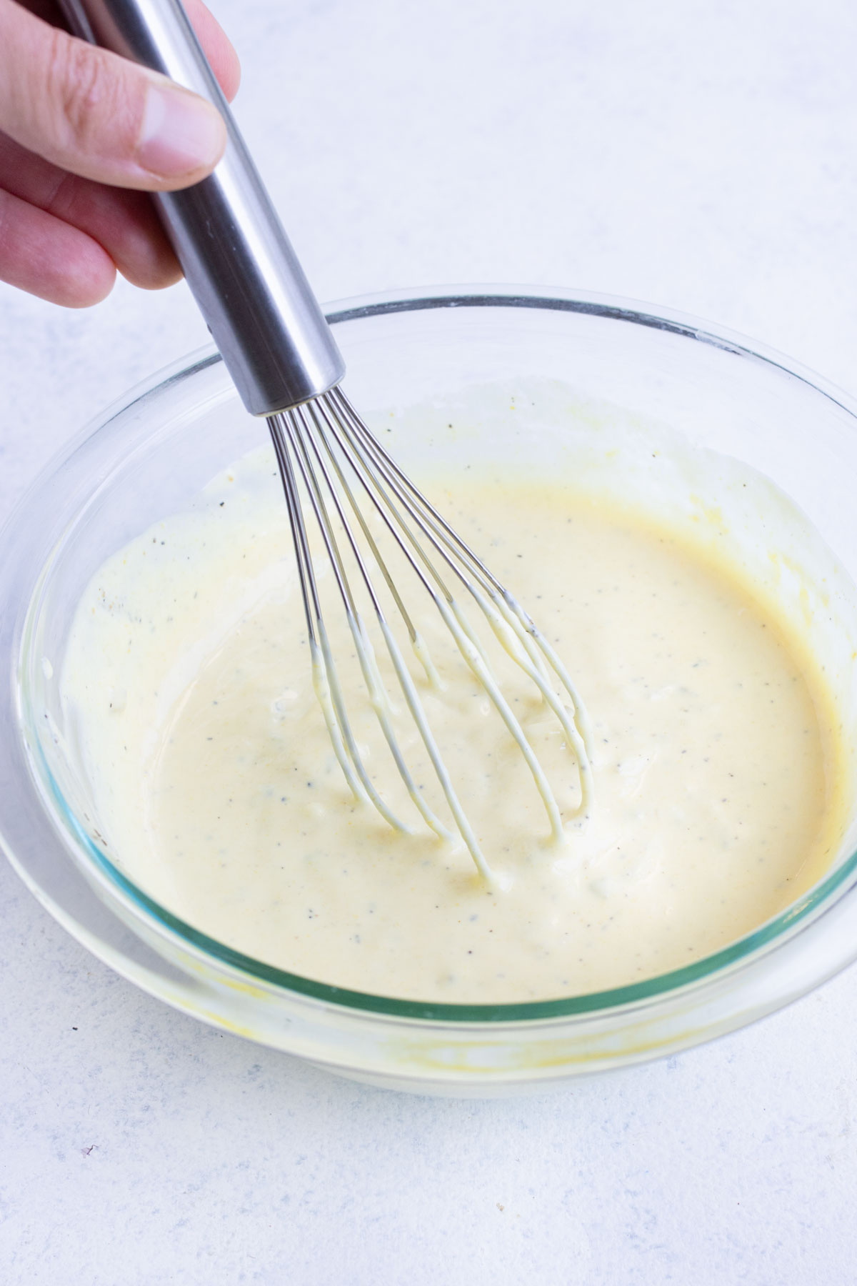 Dressing ingredients are whisked together until smooth.