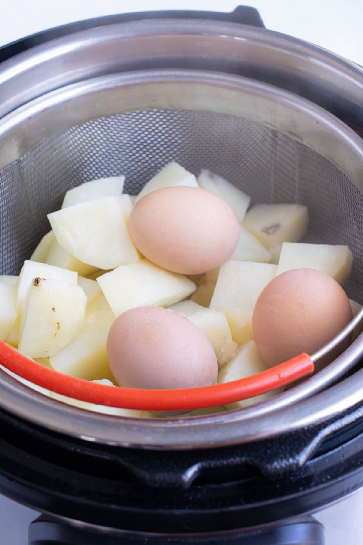 Once cooking is done, cooked eggs are removed from the soft cooked potatoes.