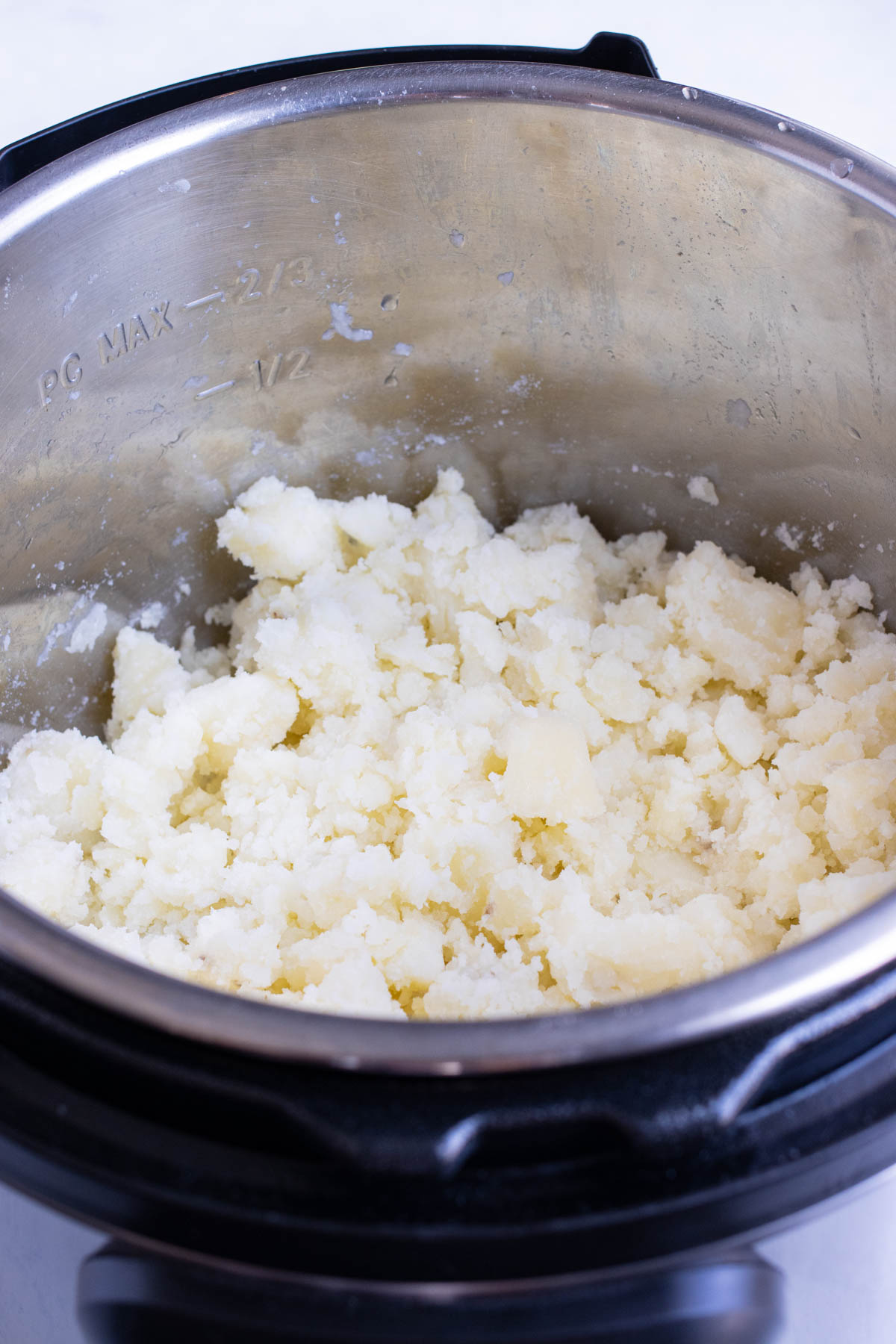 Potatoes are shown mashed in the instant pot.