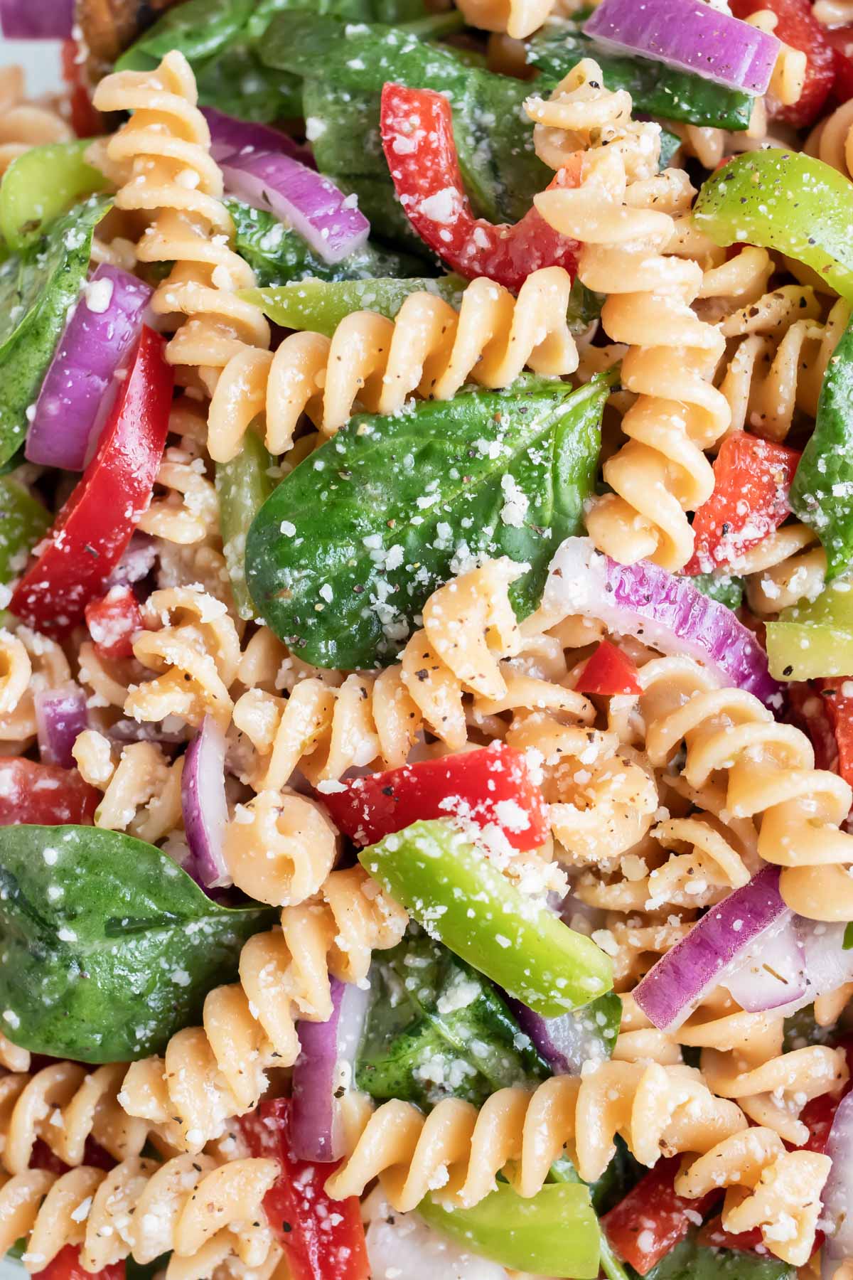 A close-up pictures of noodles, spinach, and peppers is shown for this recipe.