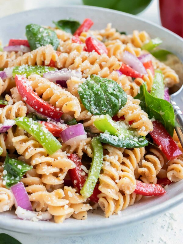 Vegetable Italian Dressing Pasta Salad is served on the counter in a white bowl.