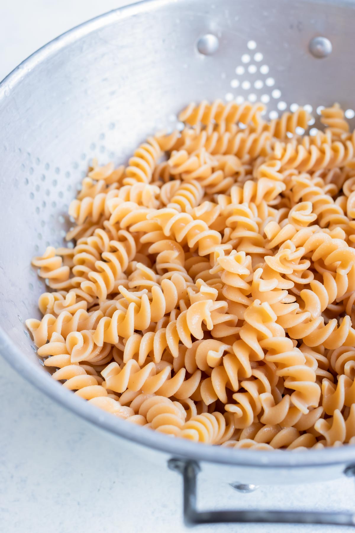 Rotini pasta is cooked and strained.