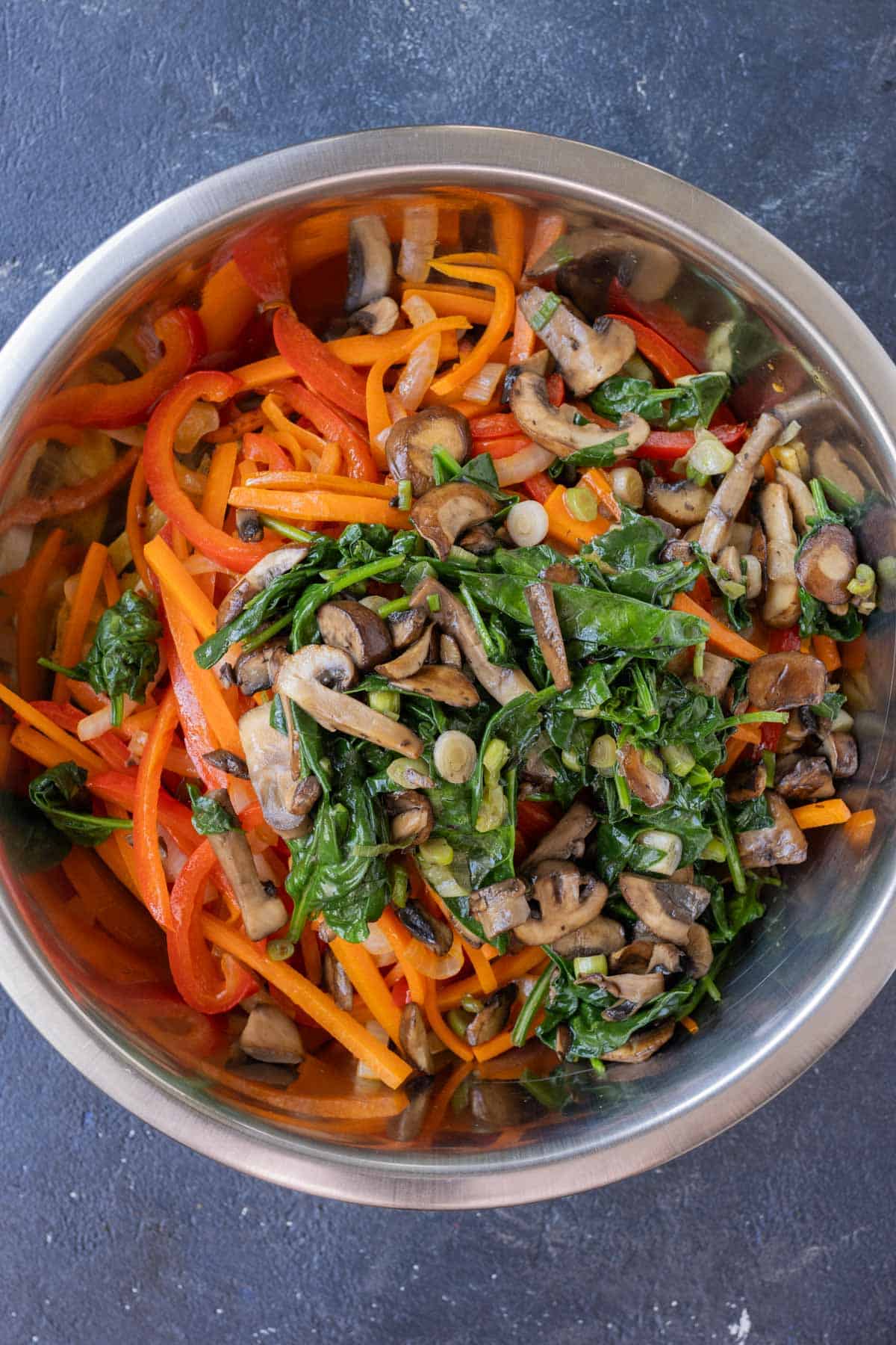 Veggies are cooked in a skillet.