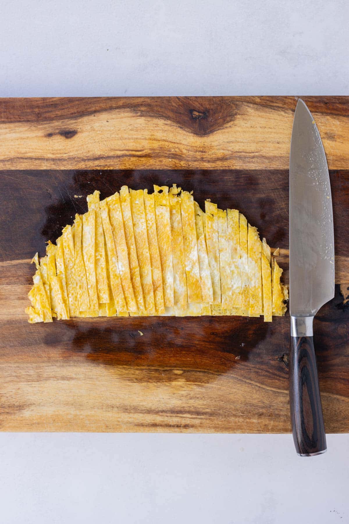 Cooked eggs are sliced thin.
