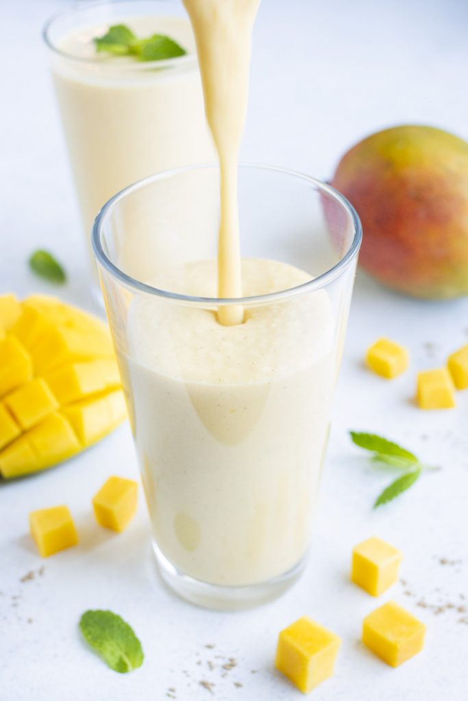 Mango Lassi is poured into a glass.