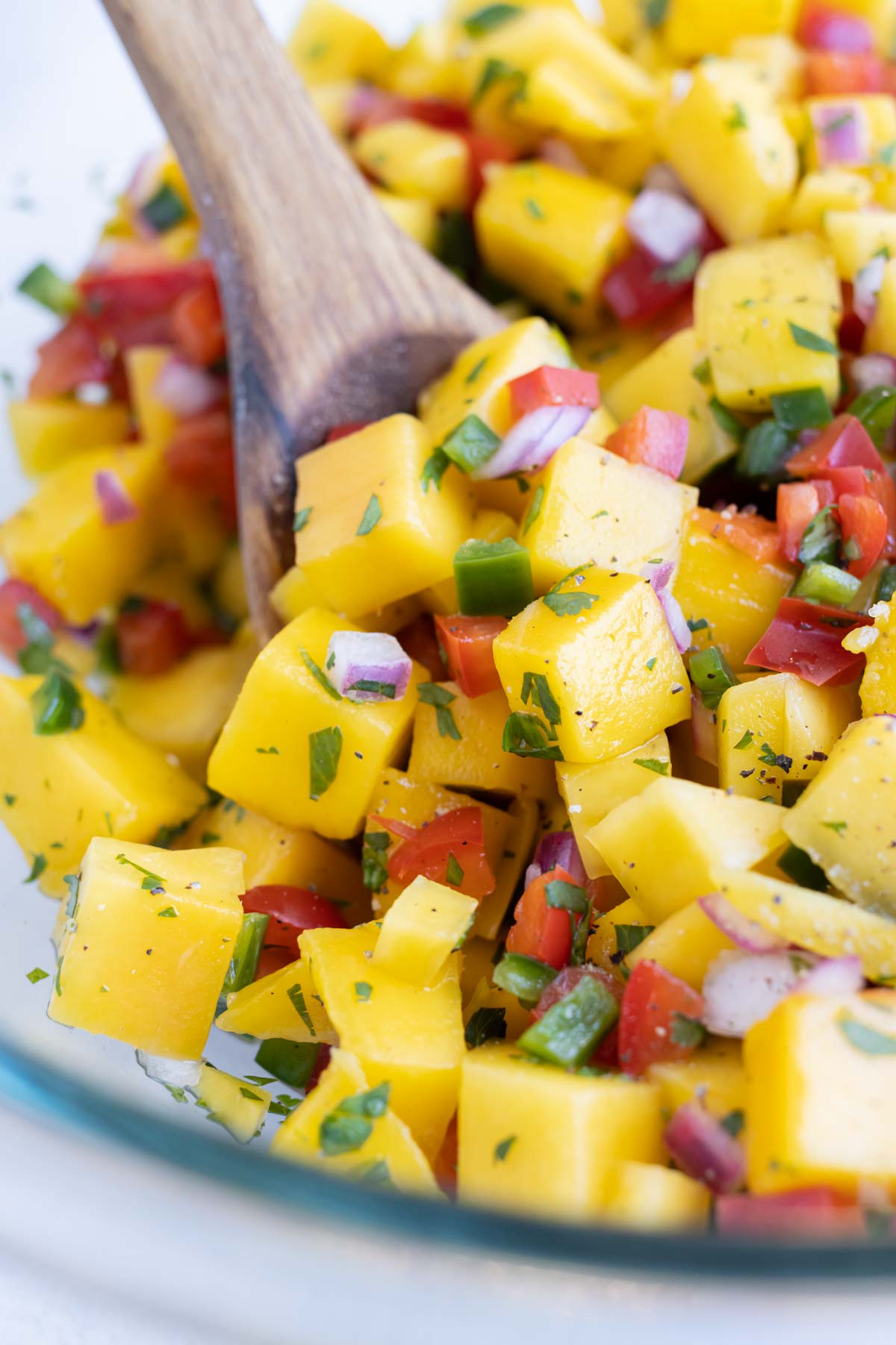 A close up pictures is used to show healthy and fresh mango salsa.
