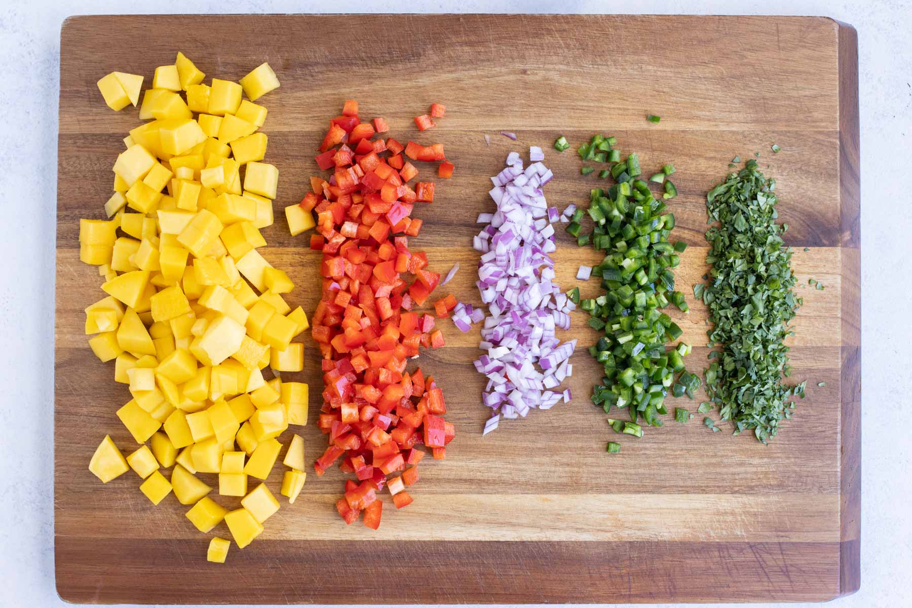 All ingredients are chopped and diced on a cutting board.