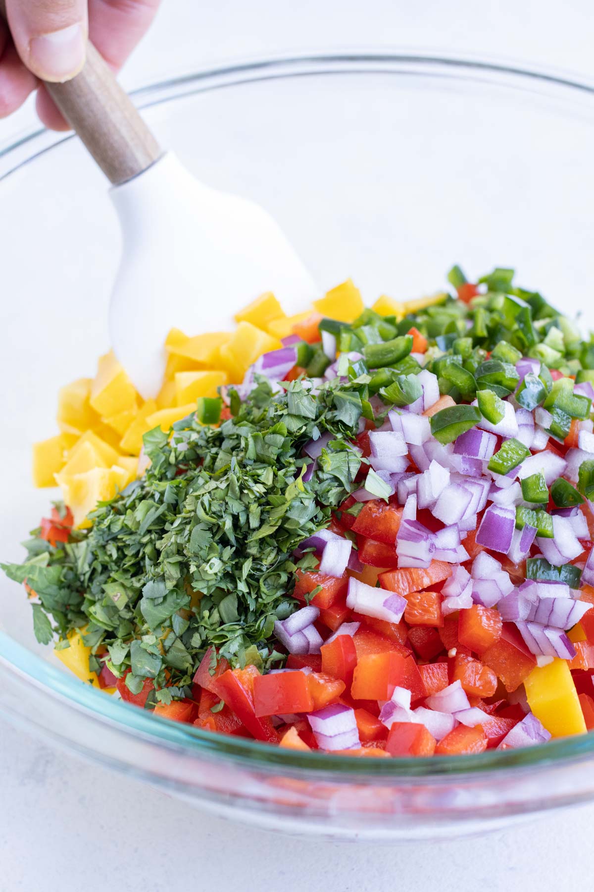 Mango and other ingredients are added to the bowl.