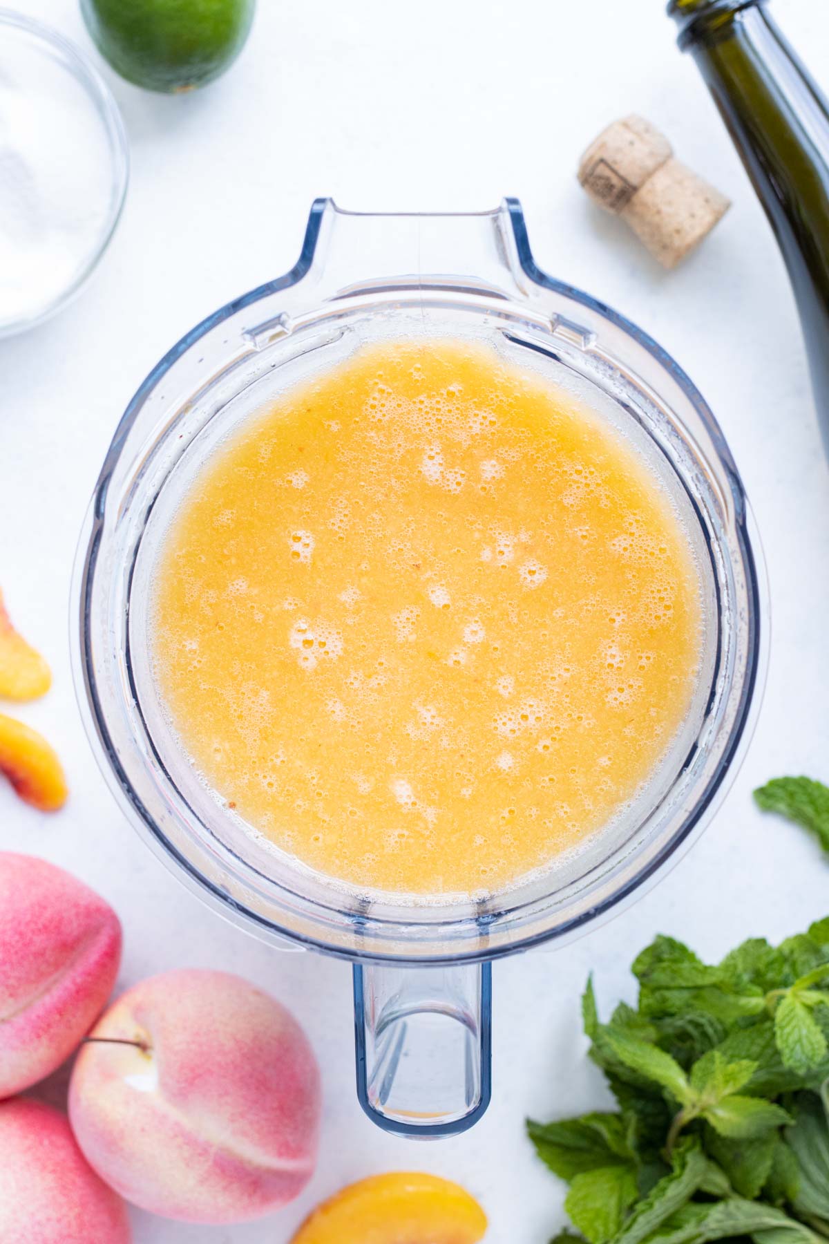 Blend peaches and Prosecco in a blender.