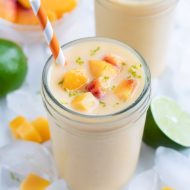 Two glasses of peach smoothies are shown for a healthy breakfast drink.