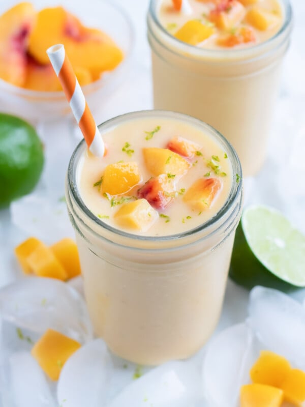 Two glasses of peach smoothies are shown for a healthy breakfast drink.