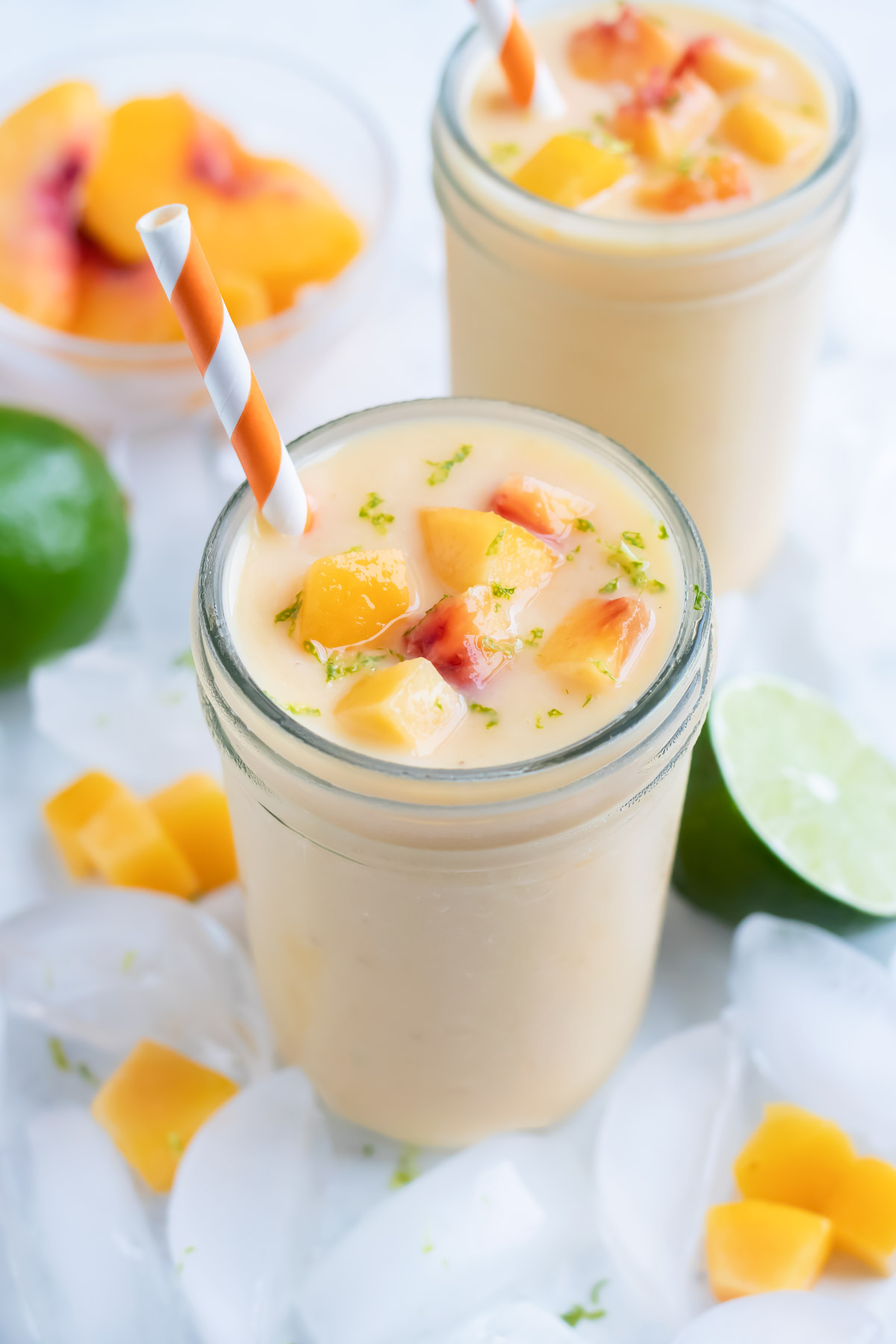 Two glasses of peach smoothies are shown for a healthy breakfast drink.