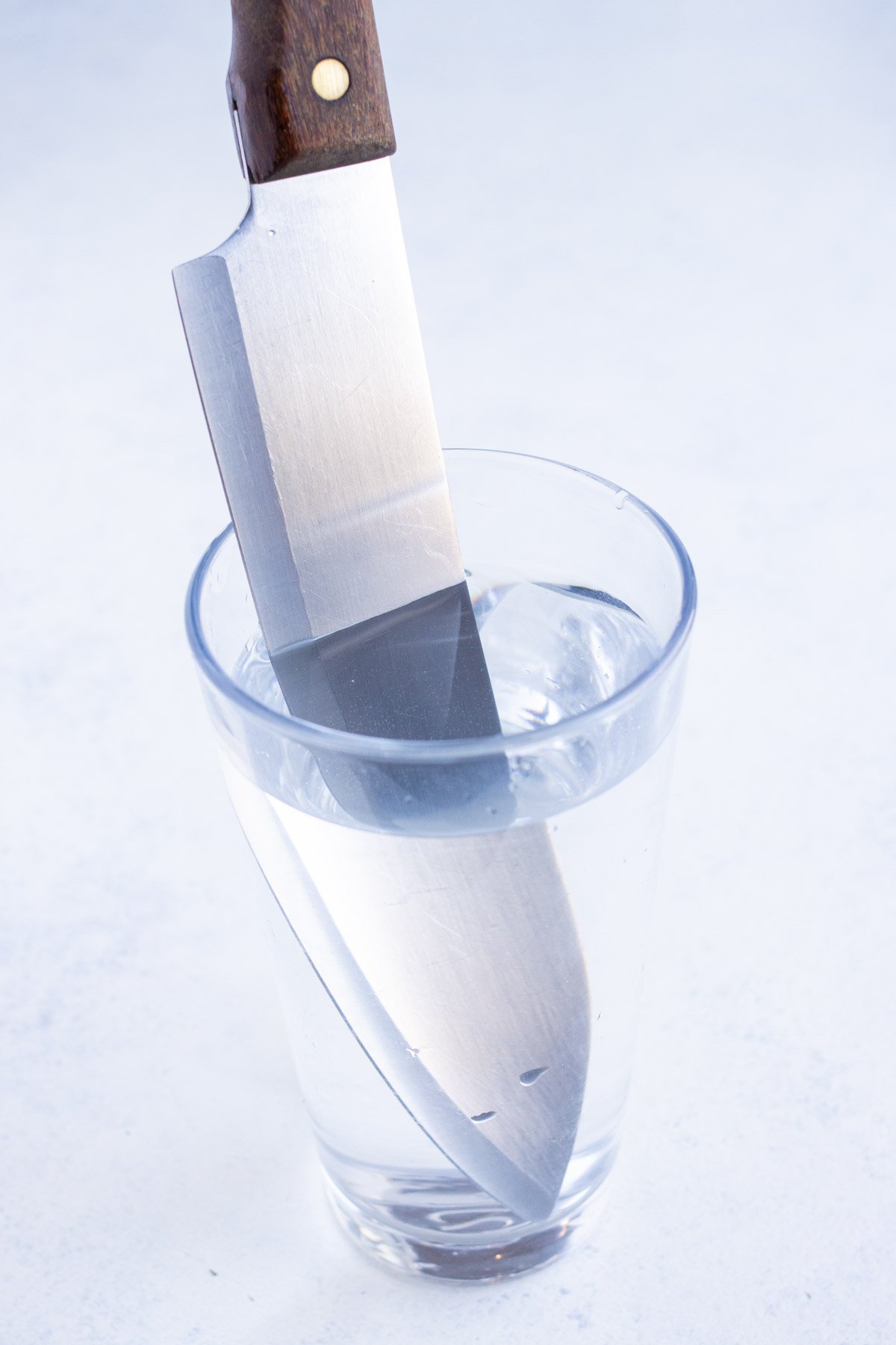 Knife is dipped into water.