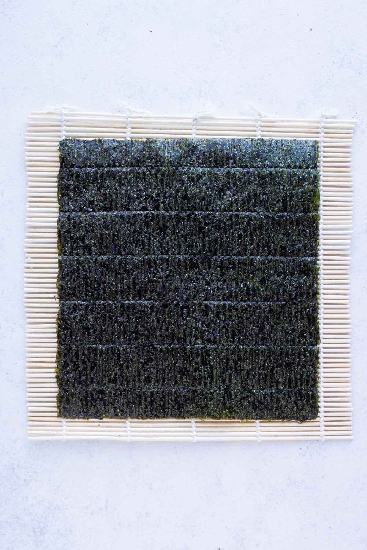Seaweed is laid on a bamboo mat.