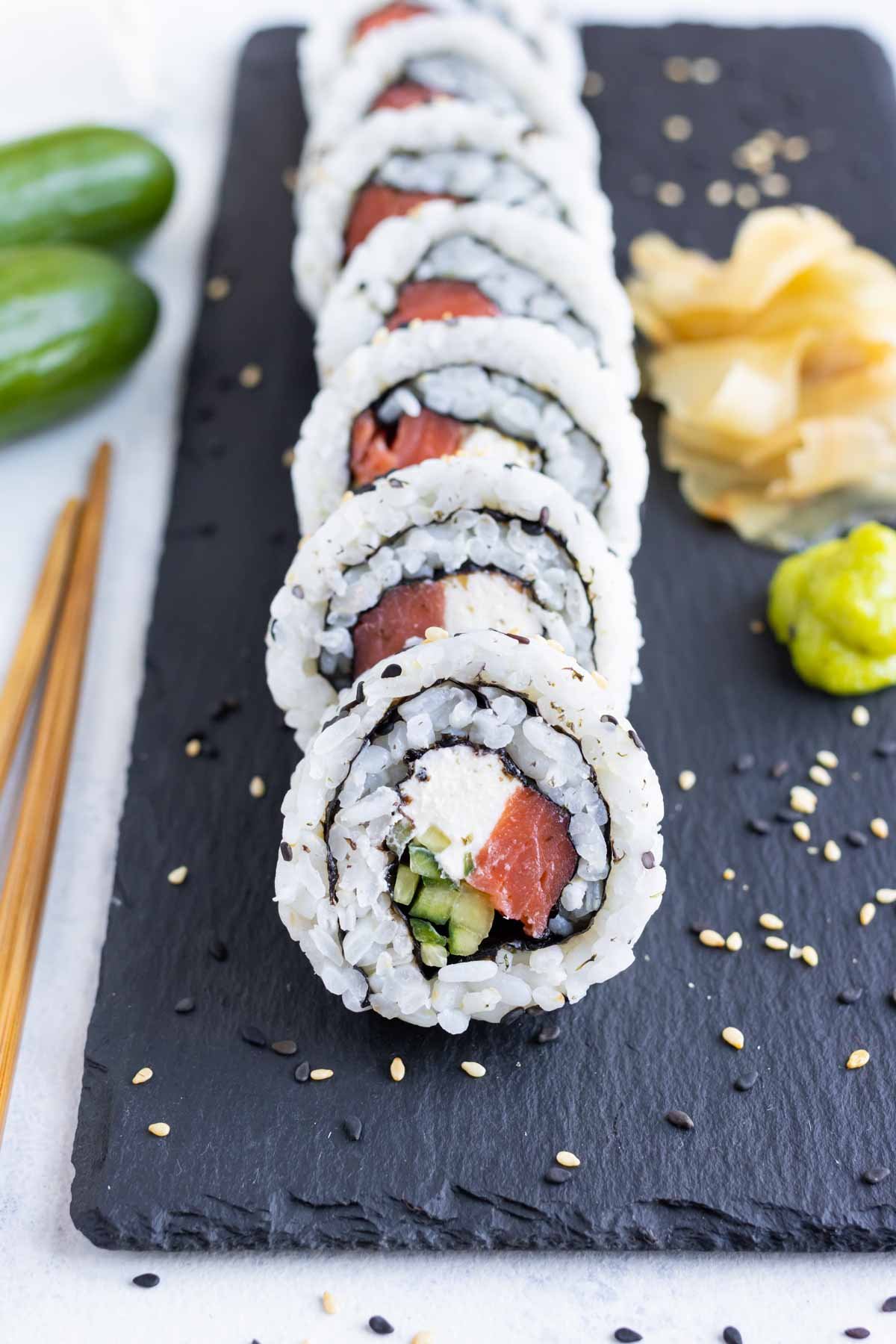 A sushi roll is cut into pieces before serving.