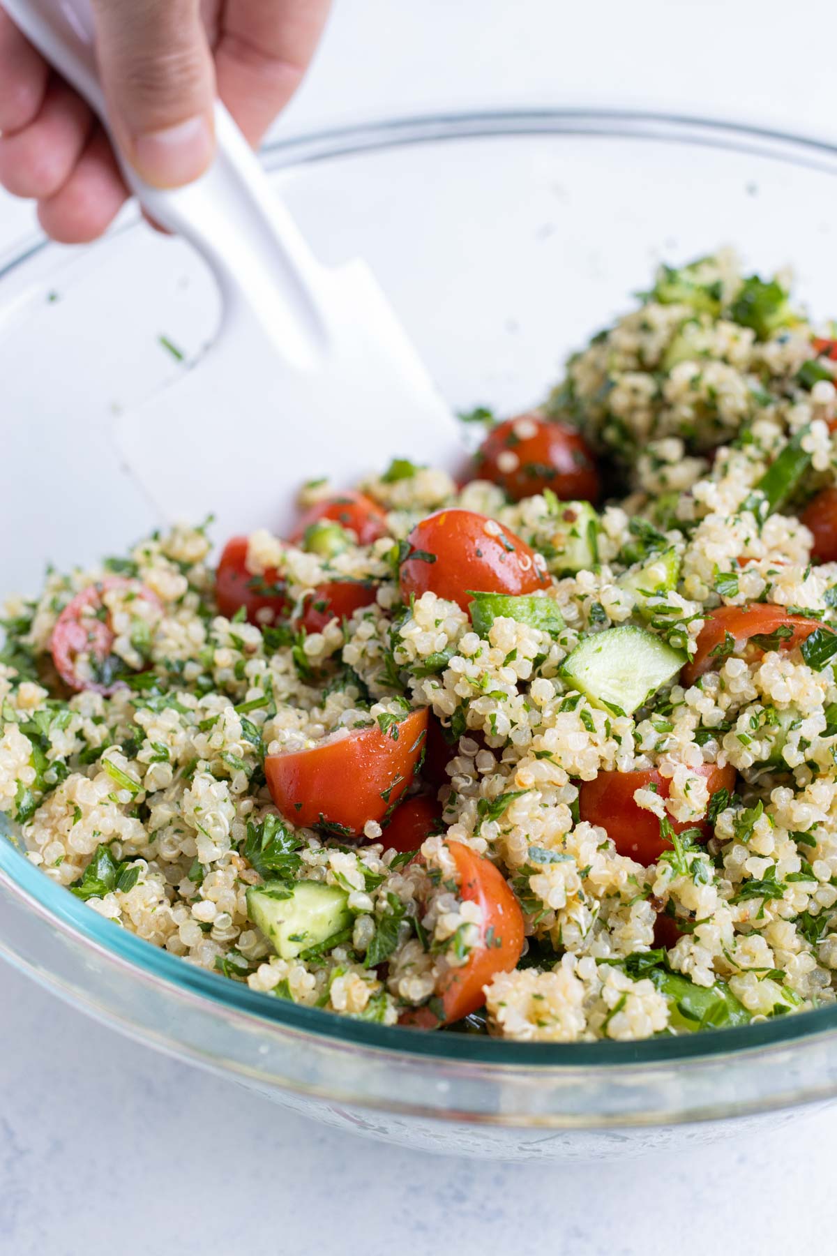 All the ingredients are folded together in a bowl with a spatula.