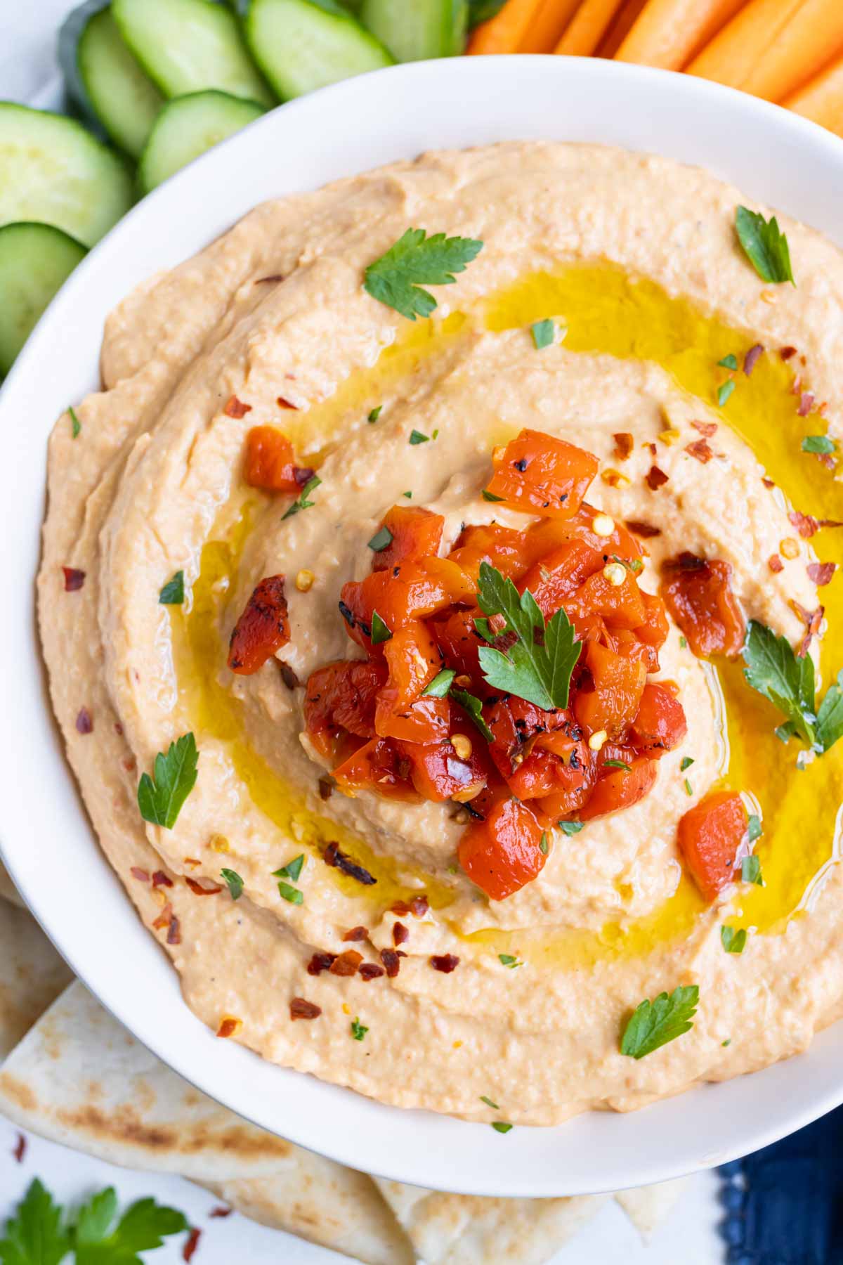 An overhead view of healthy roasted red pepper hummus.