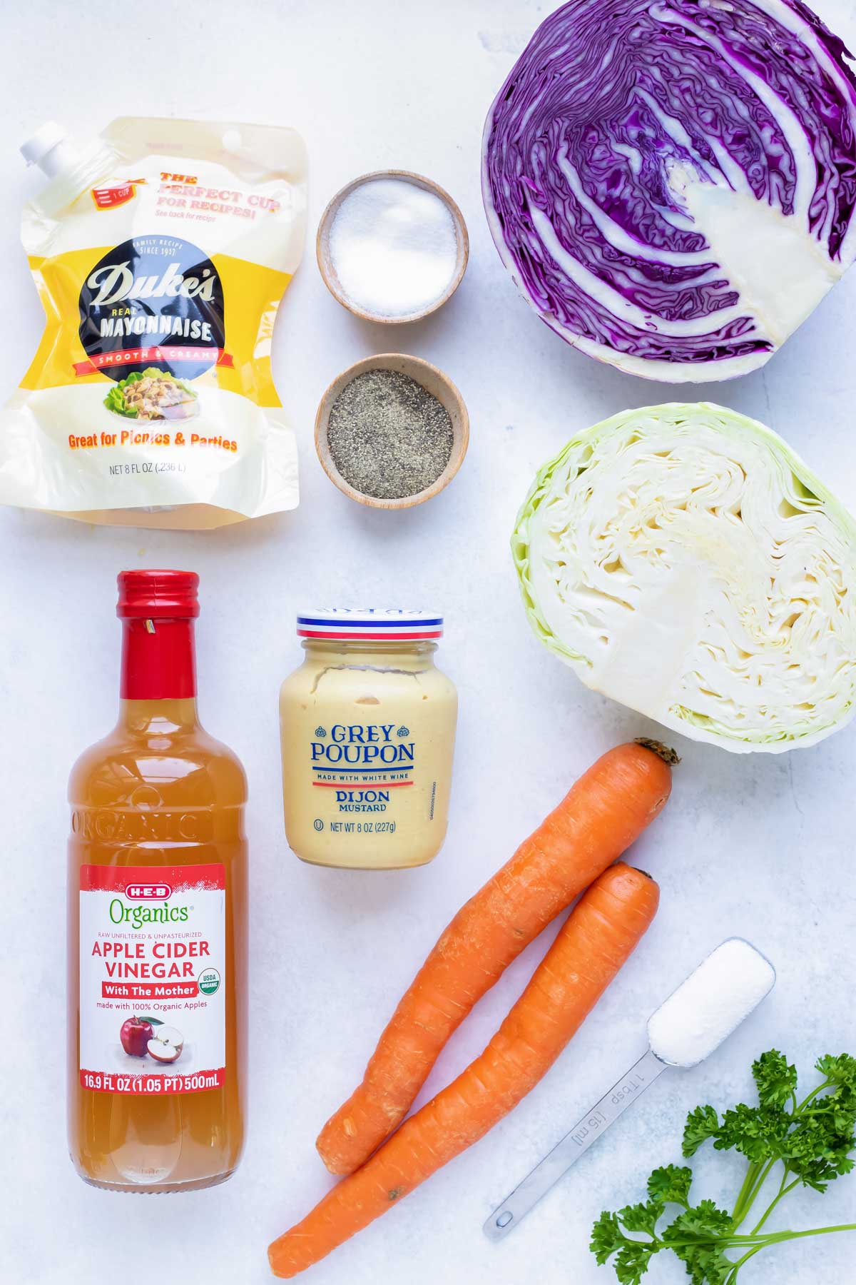 Cabbage, carrots, mayo, mustard, vinegar, and seasonings for homemade coleslaw.