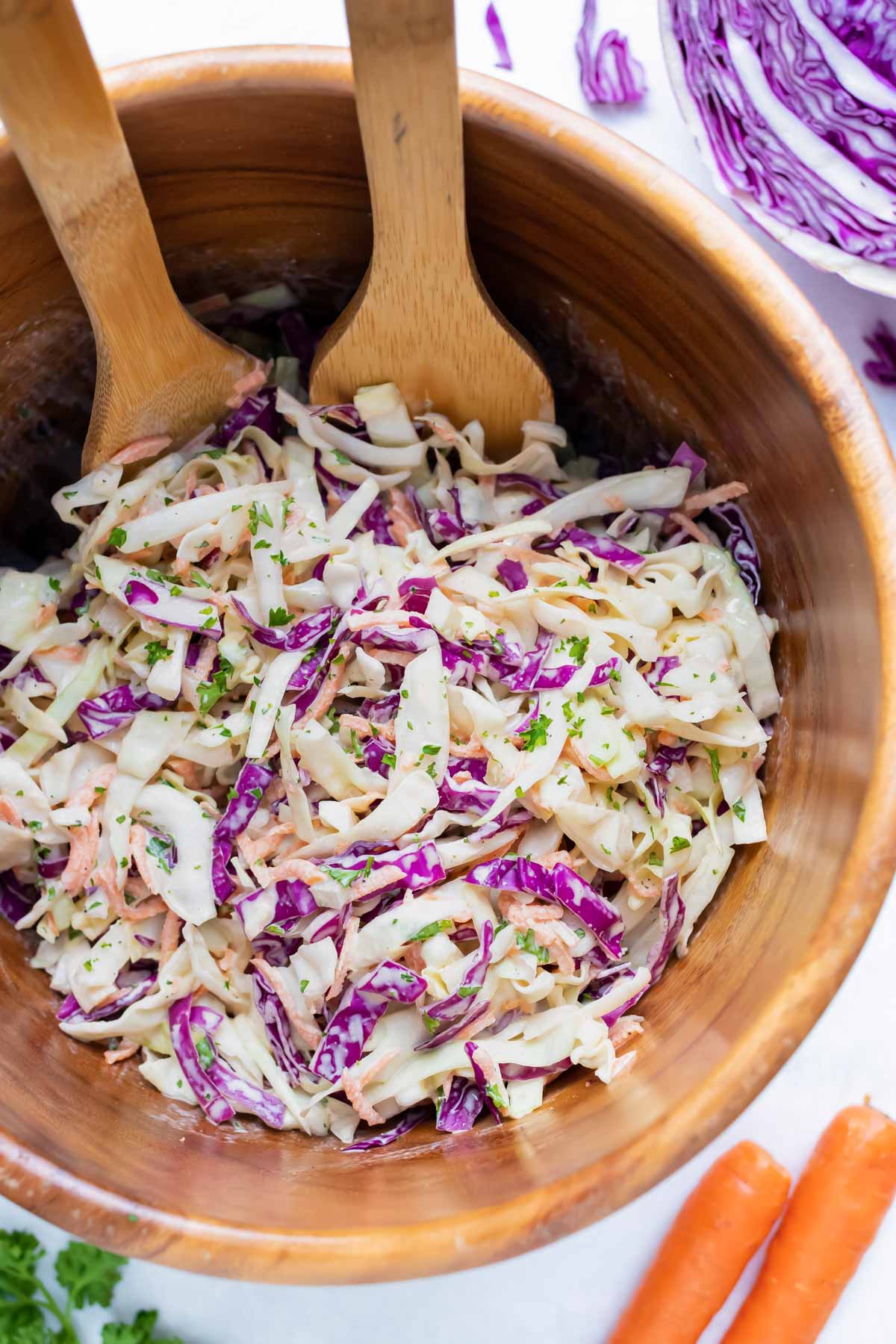 A wooden bowl full of a southern coleslaw recipe.