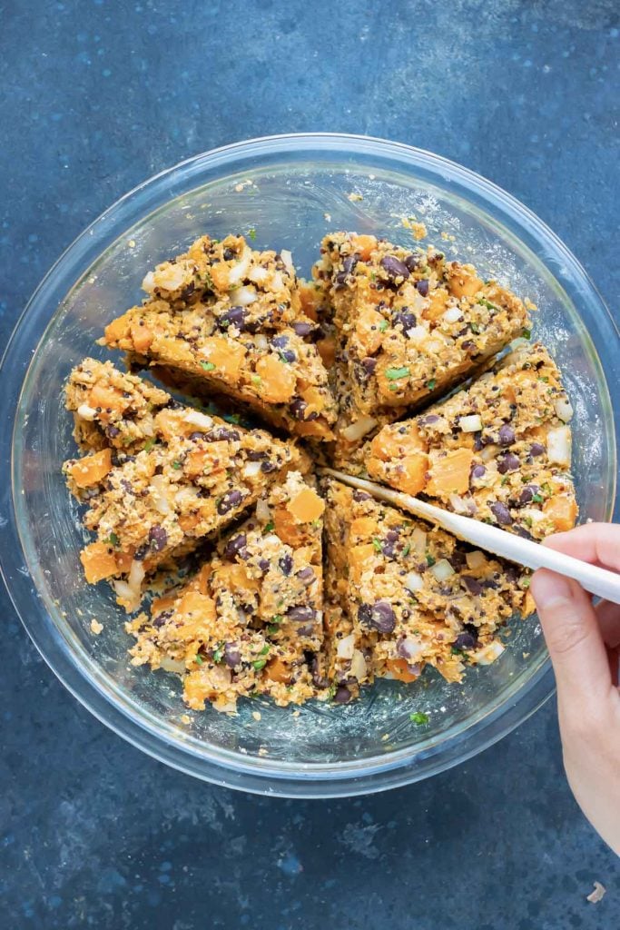Sweet potato black bean burger mixture divided into eight equal portions in a bowl.