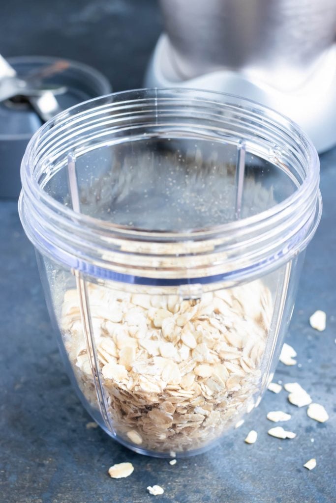 Rolled oats in a blender before being pulsed into oat flour for veggie burger patties.