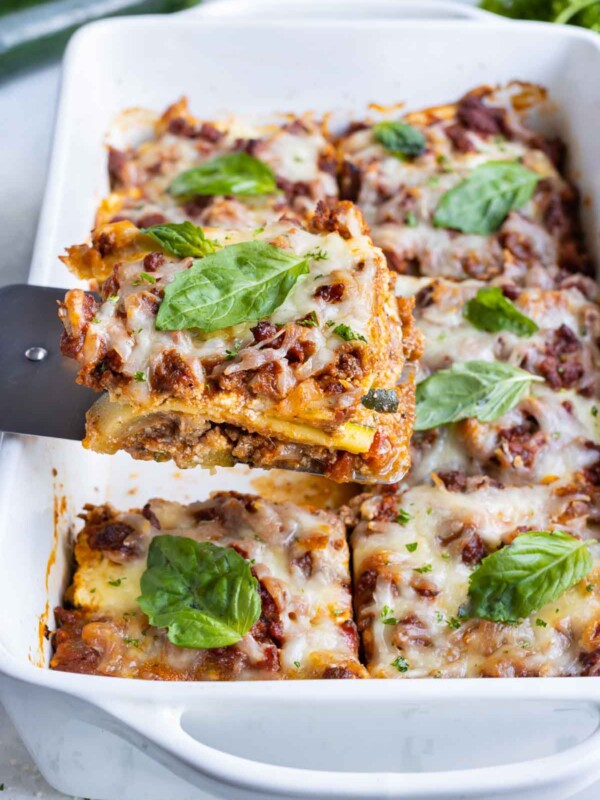 A single serving of zucchini lasagna is scooped out of the dish.