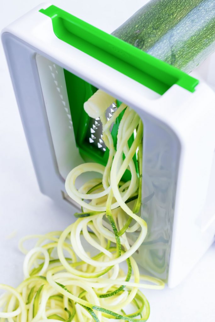 How to use a spiralizer to grate zucchini.
