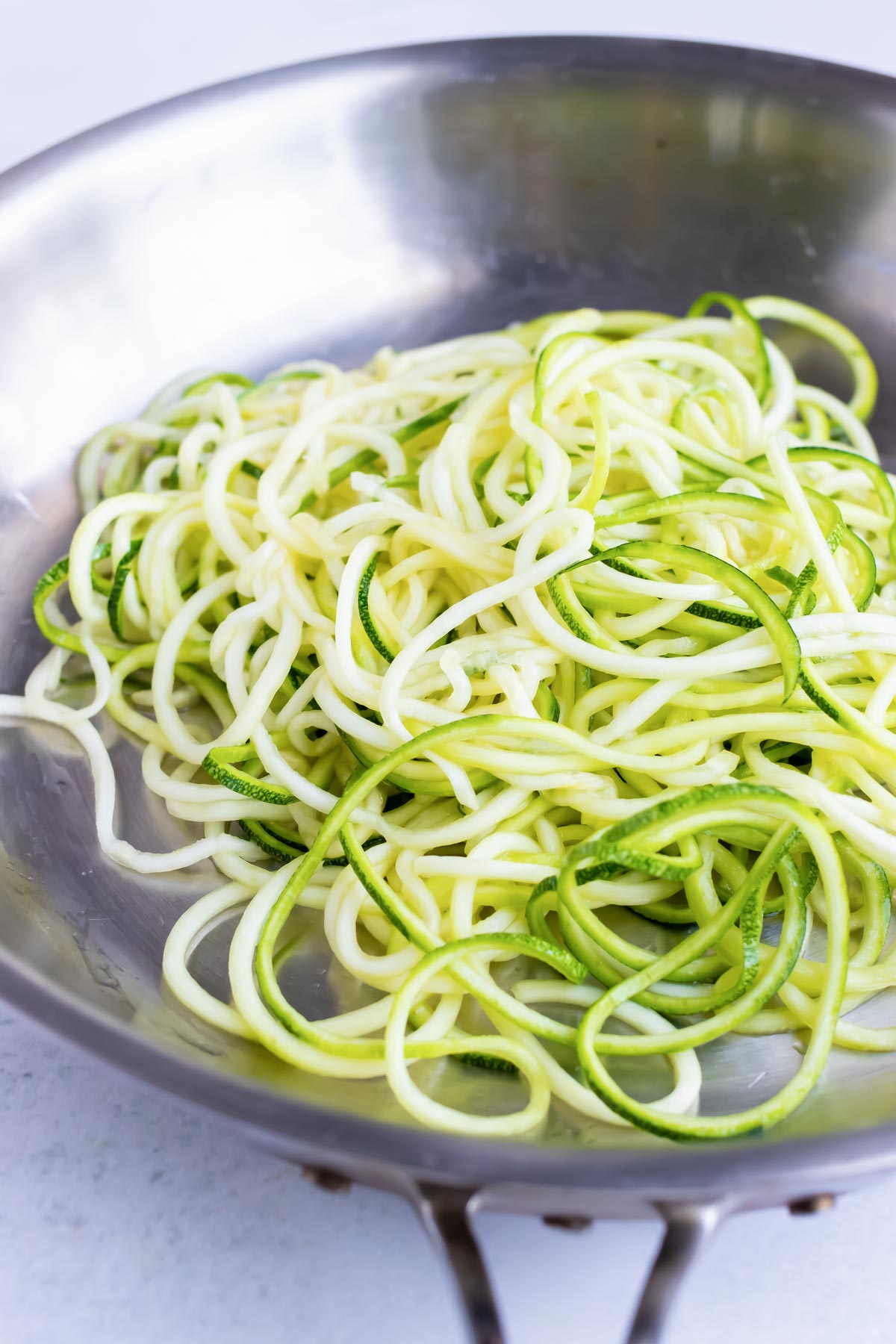 Zoodles in a skillet to cook on the stovetop.