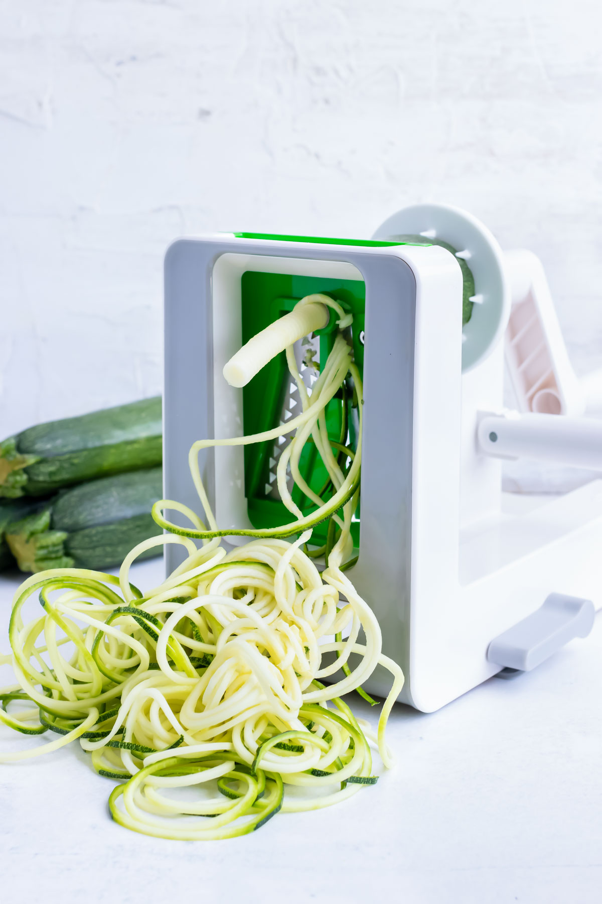 How to use a spiralizer to grate zucchini into zucchini noodles as a pasta alternative.