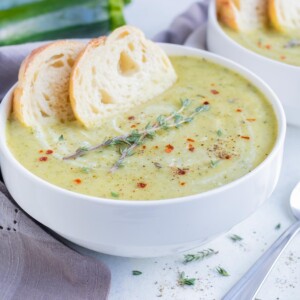 Baguette slices served with creamy zucchini soup.