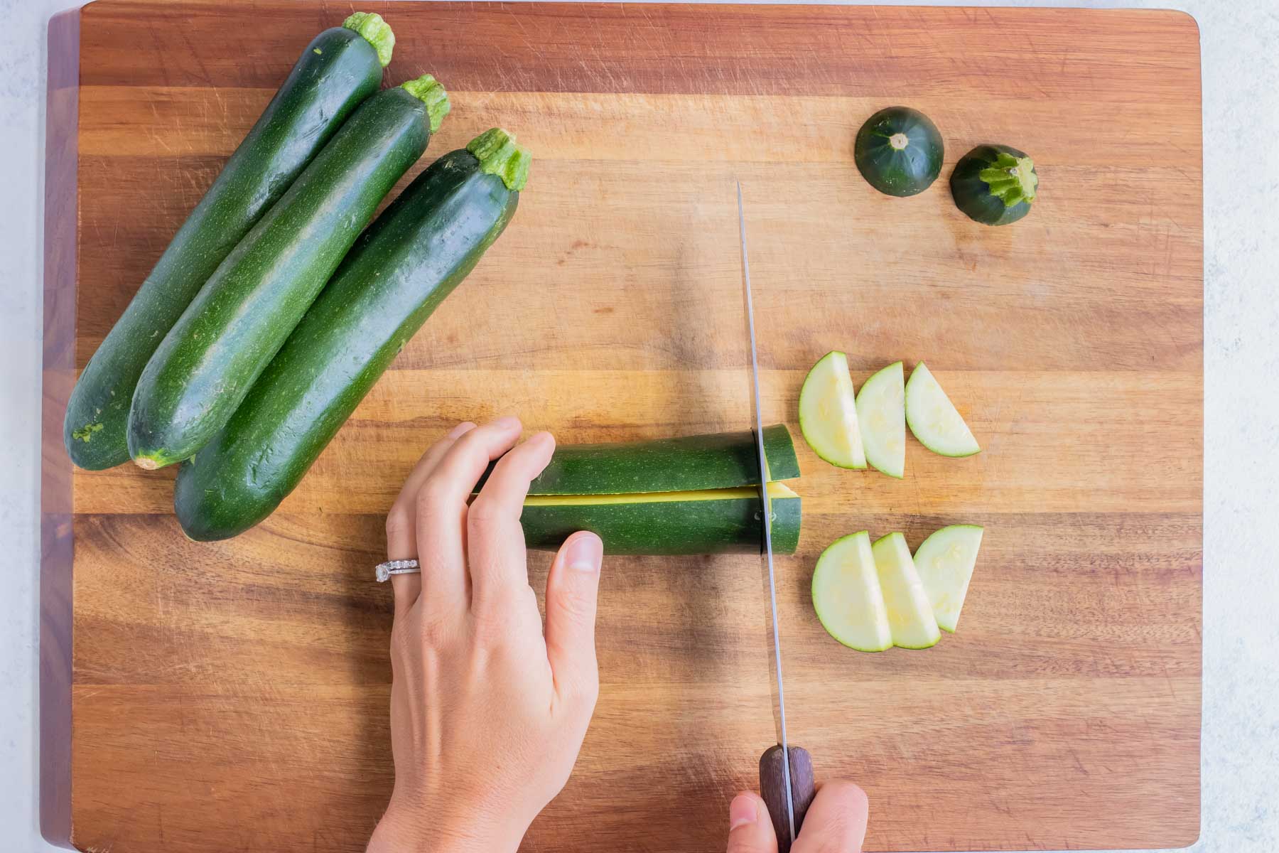 Zucchini is chopped on the cutting board.