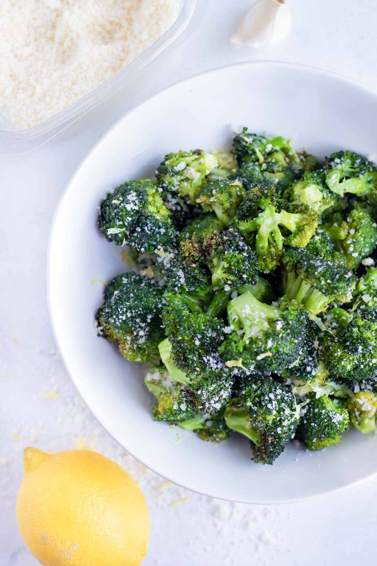 Air fryer lemon garlic broccoli is served on a white plate.