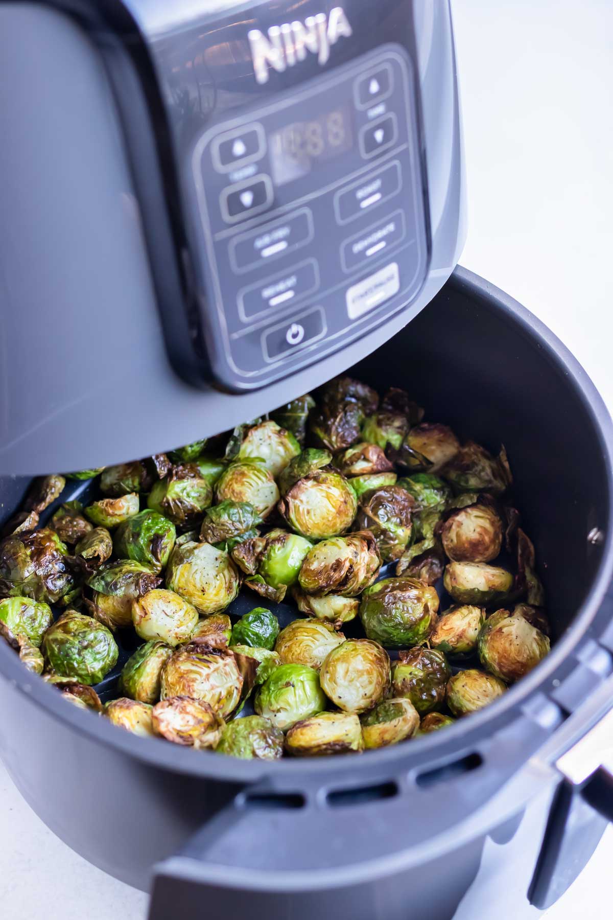 Brussels sprouts are roasted in the air fryer for a crispy and healthy side dish.