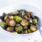 Air fryer Brussel Sprouts are served in a white bowl for a vegan side dish.