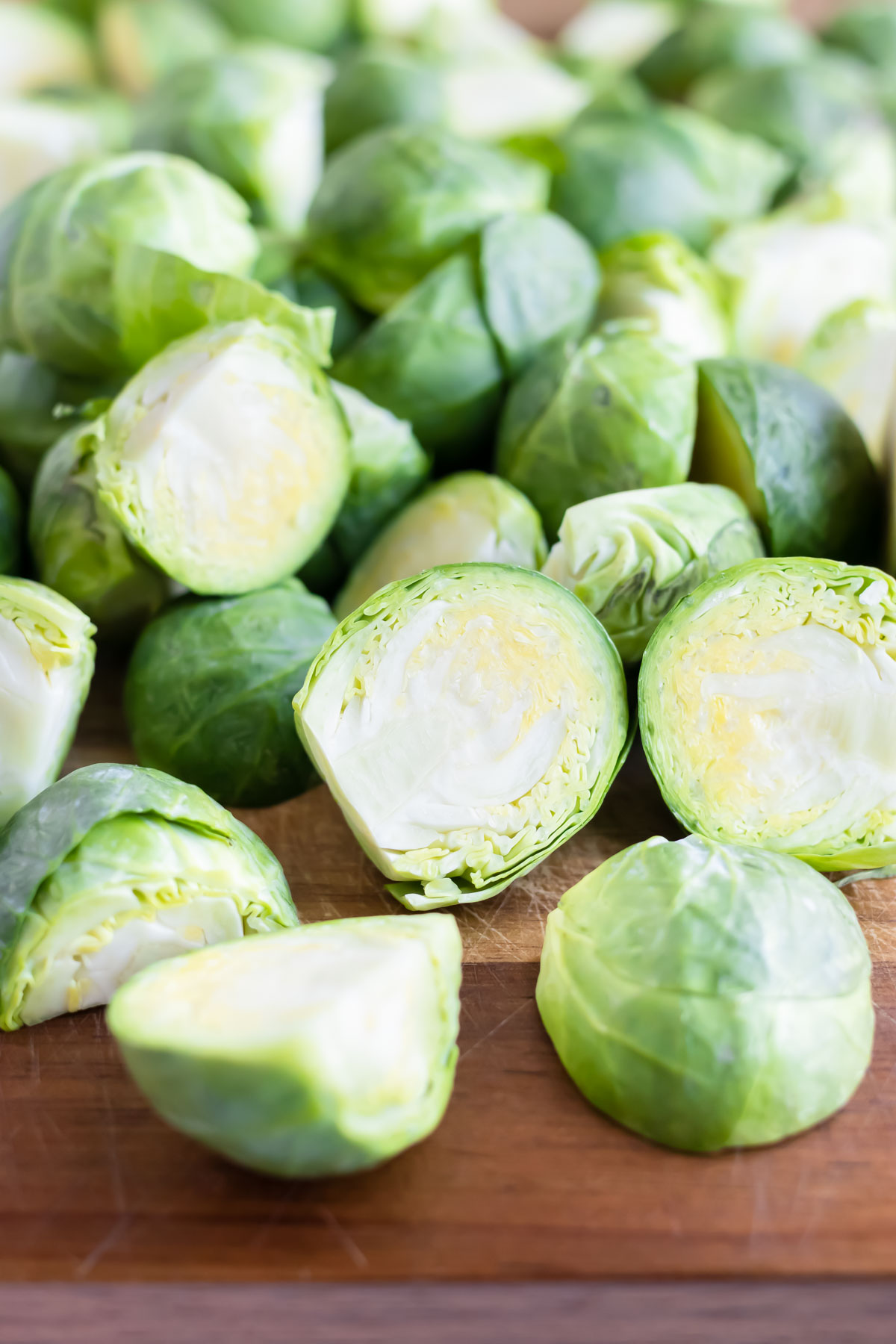 Raw Brussels sprouts are chopped and prepared for air frying.