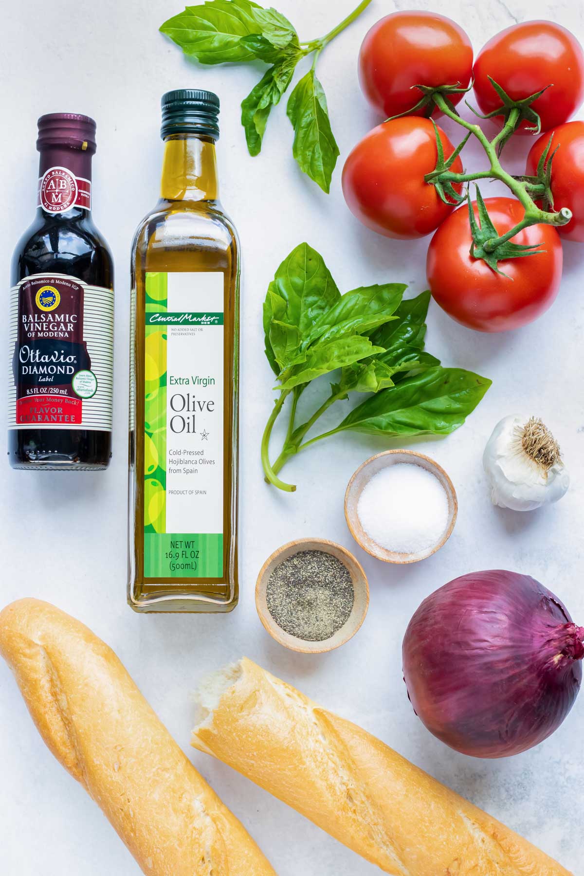 Campari vine-ripened tomatoes, olive oil, basil, balsamic vinegar, onion, and bread as the ingredients for an easy homemade bruschetta recipe.