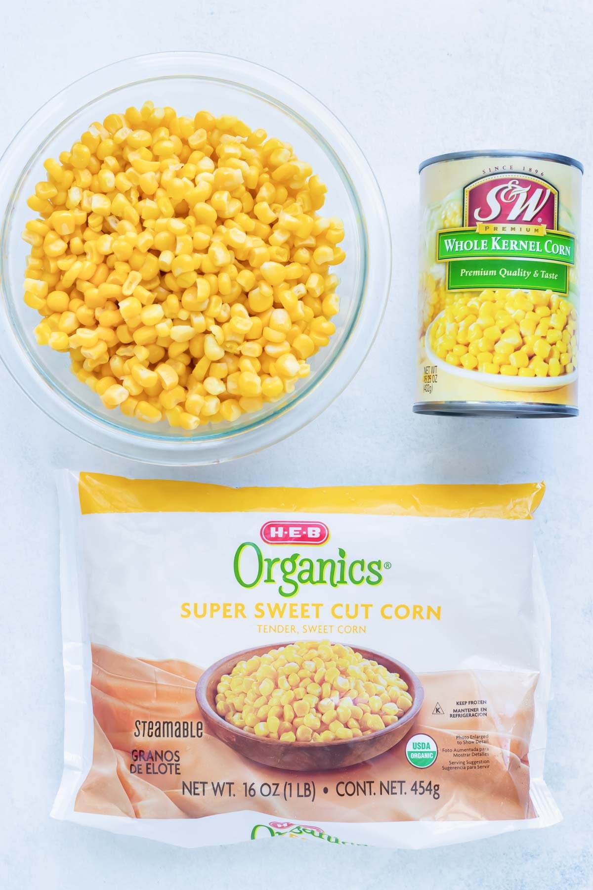 Fresh, frozen, and canned corn to be used in a homemade fritters recipe.