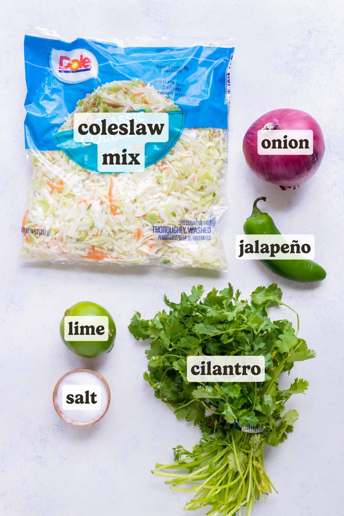 Cabbage mix, red onion, jalapeño pepper, lime, salt, and cilantro are the ingredients for this taco slaw.