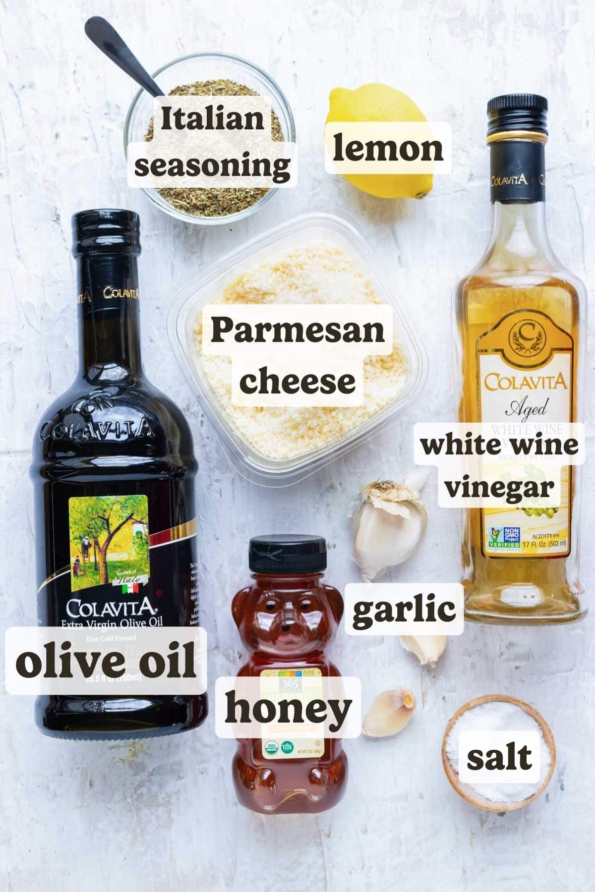 Olive oil, Parmesan cheese, honey, garlic, white wine vinegar, salt, lemon, and Italian seasonings as the ingredients for a homemade Olive Garden Italian dressing recipe.
