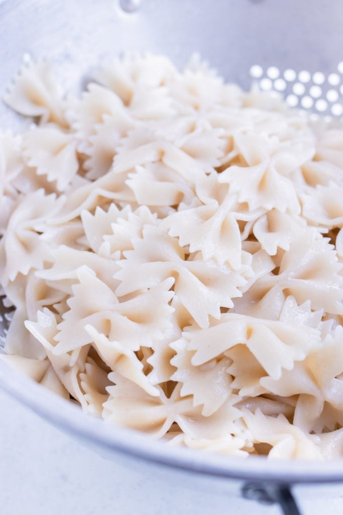 Bowtie pasta is cooked and strained before using.