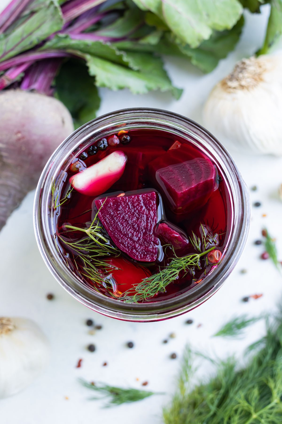 Roasted beets, garlic, dill, and pepper are brined in a jar.