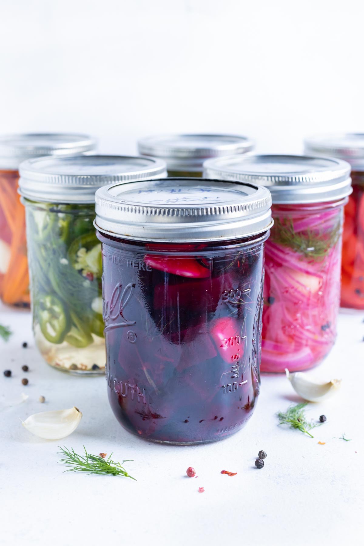 Six jars of pickled vegetables.