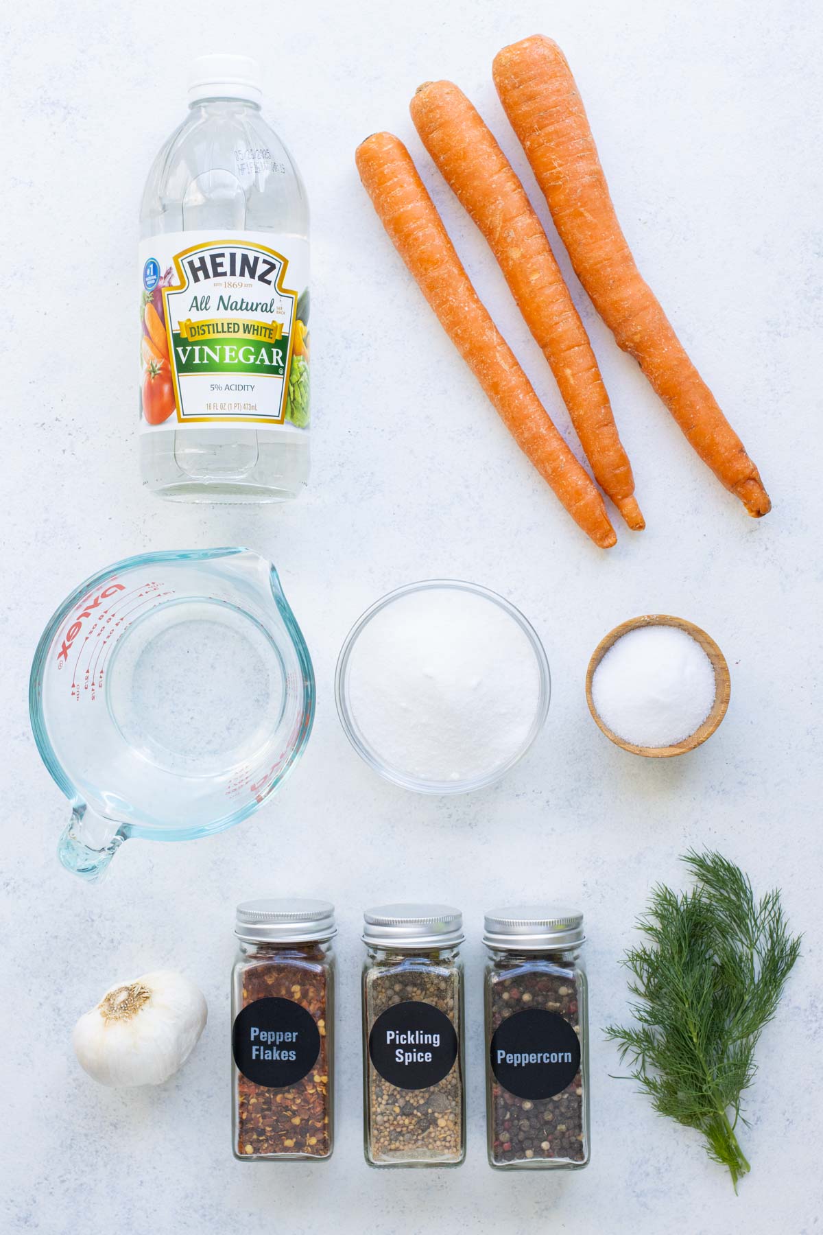 Carrots, vinegar, salt, sugar, dill, and seasonings are the ingredients for pickled carrots.