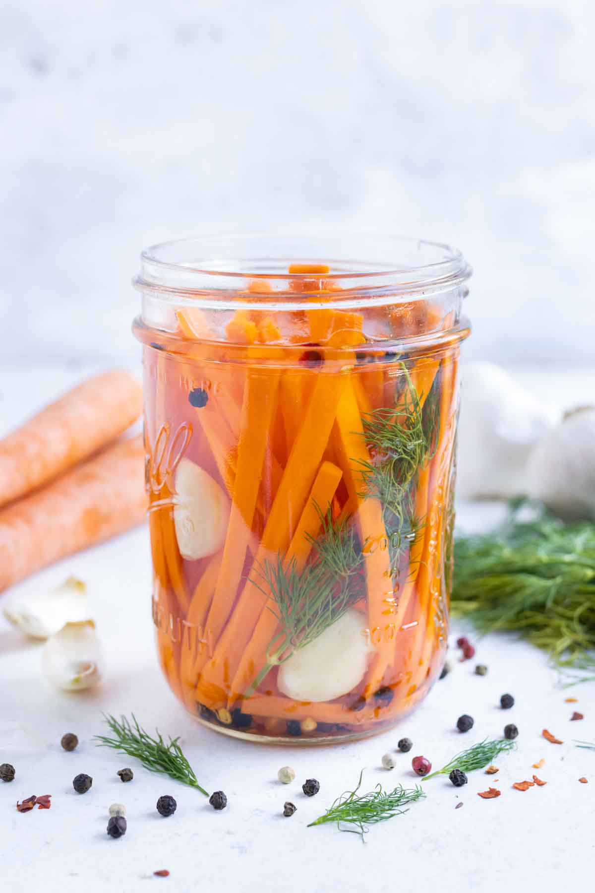 Quick Pickled Carrots RECIPE served in a Mason jar.