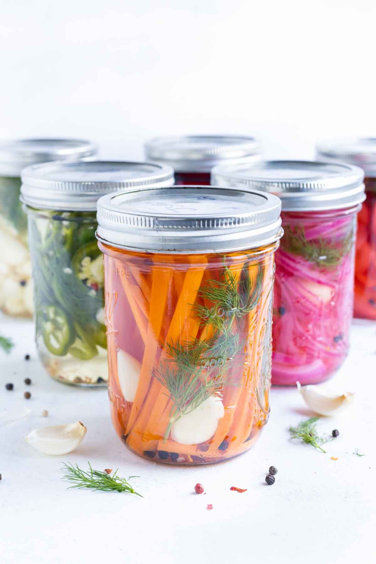 A collection of pickled vegetables in jars.