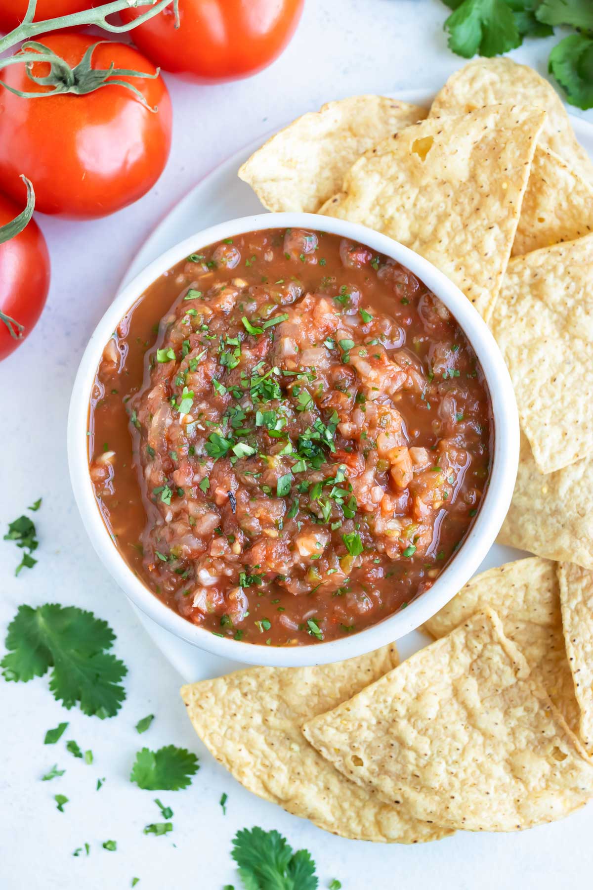 Tortilla chips are served with a big bowl of homemade salsa.