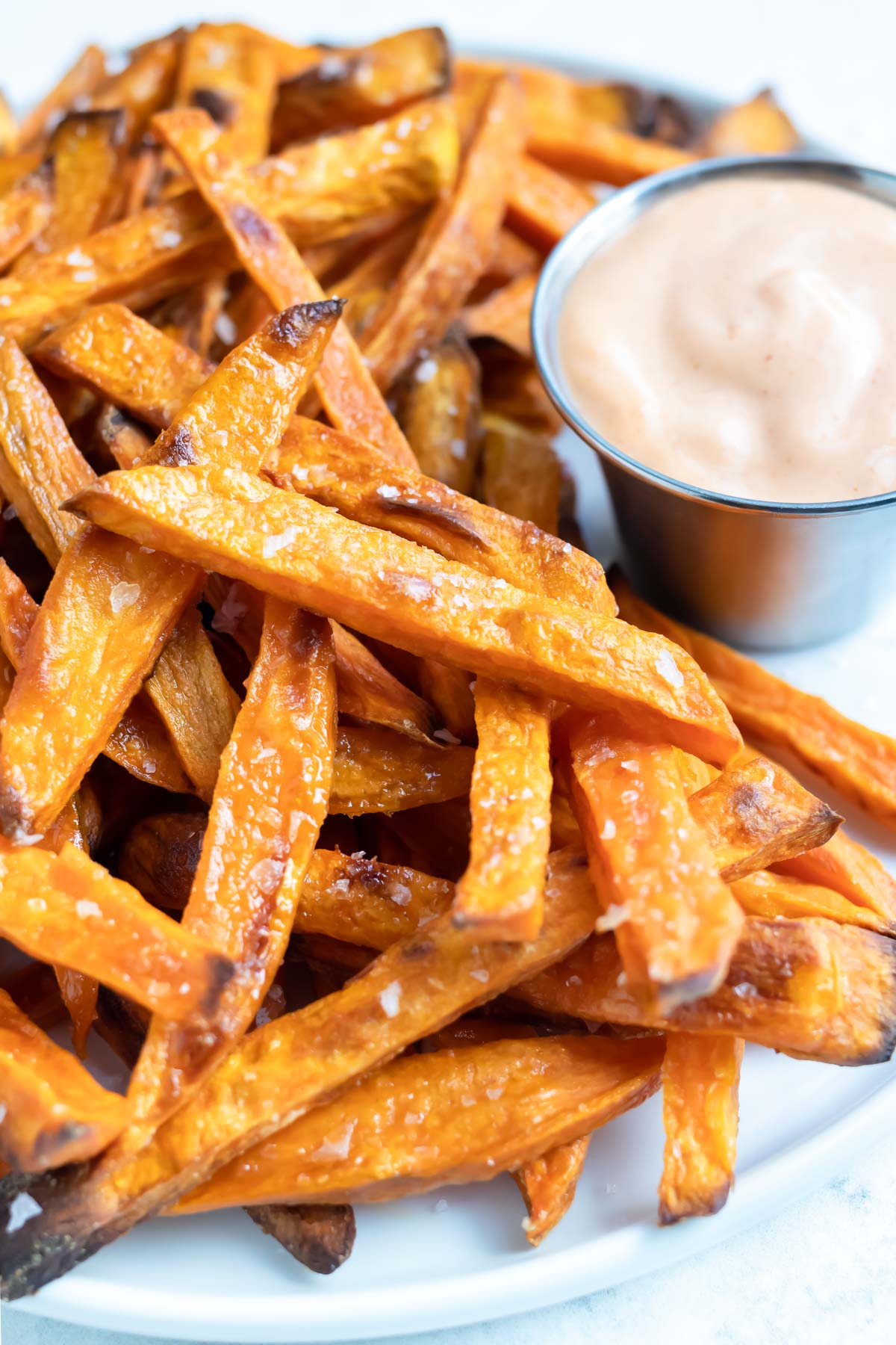 Healthy and homemade sweet potato fries served with sauce.