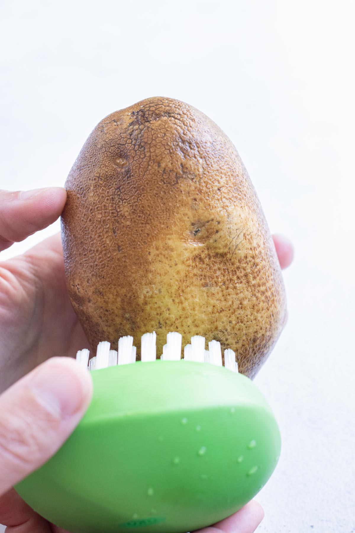 Clean the outside of the potato with a brush.